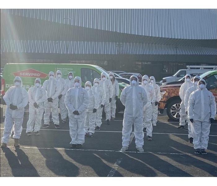 SERVPRO techs donned in PPE in front of arena, awaiting instructiontruction